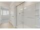 Bathroom showcasing a glass-enclosed shower with white tiled walls and chrome fixtures at 17959 Dandy Brush Ln, Parker, CO 80134