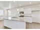 Modern white kitchen with a large island, stainless steel appliances, and granite countertops at 17959 Dandy Brush Ln, Parker, CO 80134