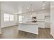 Modern white kitchen with a large island, stainless steel appliances, and granite countertops at 17959 Dandy Brush Ln, Parker, CO 80134