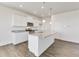 Open kitchen features an island with granite countertops, white cabinets, and stainless steel appliances at 17959 Dandy Brush Ln, Parker, CO 80134