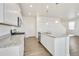 Well-lit kitchen featuring stainless appliances, white cabinets, and a granite countertop island at 17959 Dandy Brush Ln, Parker, CO 80134