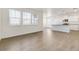 Bright, open living area with hardwood floors, white walls, and views into the kitchen at 17959 Dandy Brush Ln, Parker, CO 80134