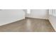 Bright, open living area with hardwood floors, white walls, and views into the stairway at 17959 Dandy Brush Ln, Parker, CO 80134