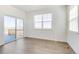 Spacious living room with wood floors, natural light, and access to a patio at 17959 Dandy Brush Ln, Parker, CO 80134