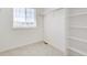 Bright, carpeted walk-in closet with shelving and a window for natural light at 17959 Dandy Brush Ln, Parker, CO 80134