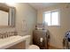 A compact bathroom featuring modern fixtures, a sink with storage, and a washing machine with a dryer at 321 S 26Th Ave, Brighton, CO 80601