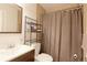 Compact bathroom featuring tiled walls, a sink with vanity, a toilet and shower with curtain at 321 S 26Th Ave, Brighton, CO 80601