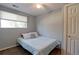 Cozy bedroom features a white bed, soft natural light from the window, and a ceiling fan to ensure comfort at 321 S 26Th Ave, Brighton, CO 80601