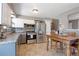 Bright kitchen features stainless appliances, white and gray cabinets, a dining table at 321 S 26Th Ave, Brighton, CO 80601