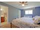Serene main bedroom with blue walls, a large window, and an en-suite bathroom at 321 S 26Th Ave, Brighton, CO 80601