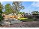 Fenced-in backyard with grass lawn, stone patio and detached garage at 1633 Gaylord St, Denver, CO 80206