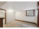 Basement area featuring neutral carpet, base trim, and one window at 1633 Gaylord St, Denver, CO 80206