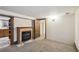 Basement living space with a fireplace, neutral carpet, and wood trim at 1633 Gaylord St, Denver, CO 80206