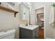 Updated bathroom featuring a vanity with a mirror cabinet and a wood accent shelf at 1633 Gaylord St, Denver, CO 80206