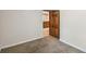 Carpeted bedroom with base trim and open doorway to kitchen at 1633 Gaylord St, Denver, CO 80206