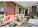 Relaxing front porch seating area with a vibrant front door offering a warm welcome to guests at 1633 Gaylord St, Denver, CO 80206