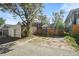 A detached garage at the rear of the property with ample parking space, surrounded by a wooden fence at 1633 Gaylord St, Denver, CO 80206