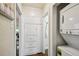 Hallway with a stackable washer/dryer and built-in storage cabinets at 1633 Gaylord St, Denver, CO 80206