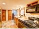 Traditional kitchen features stainless appliances, granite counters, and tile backsplash at 1633 Gaylord St, Denver, CO 80206