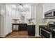 Kitchen with granite countertops, stainless steel appliances, and wood floors at 1633 Gaylord St, Denver, CO 80206