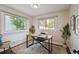 Bright home office with natural light, featuring a neutral color scheme and wood desk at 1633 Gaylord St, Denver, CO 80206