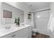 Well-lit bathroom features double vanity, modern fixtures, and a shower-tub combo at 11845 W Tulane Dr, Morrison, CO 80465