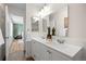Bright bathroom with double sinks, modern vanity, and neutral decor at 11845 W Tulane Dr, Morrison, CO 80465