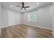 Bright bedroom featuring light gray walls, light wood floors, large closet, and a ceiling fan at 11845 W Tulane Dr, Morrison, CO 80465