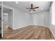 Bedroom featuring light gray walls, light wood floors, a large closet, and ceiling fan at 11845 W Tulane Dr, Morrison, CO 80465