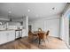 A dining area featuring a round table, sliding glass doors to the backyard, and an adjacent kitchen at 11845 W Tulane Dr, Morrison, CO 80465