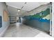 Spacious garage with wall mural, utility shelving, and ample room for storage and vehicles at 11845 W Tulane Dr, Morrison, CO 80465