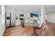 Eat-in kitchen featuring stainless steel appliances, sleek white cabinets and stylish decor at 11845 W Tulane Dr, Morrison, CO 80465