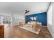 Bright living room featuring a striking blue accent wall and modern decor at 11845 W Tulane Dr, Morrison, CO 80465