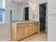 Bright bathroom with double sinks, a large mirror, and ample cabinet space at 275 Gold Maple St, Brighton, CO 80601