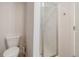 Bright bathroom featuring a toilet, glass shower, and white walls at 275 Gold Maple St, Brighton, CO 80601