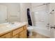 Bright bathroom featuring a vanity with a sink, a shower with tile surround and a commode at 275 Gold Maple St, Brighton, CO 80601