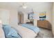 Carpeted bedroom with vaulted ceiling featuring natural light and a seating area at 275 Gold Maple St, Brighton, CO 80601