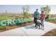 Community dog park and walking path with signage in the background for residents to enjoy at 275 Gold Maple St, Brighton, CO 80601