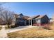 Charming blue two-story home featuring an attached garage, a well-maintained lawn, and inviting curb appeal at 275 Gold Maple St, Brighton, CO 80601