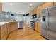 Spacious kitchen features stainless appliances, light wood cabinets, and hardwood floors at 275 Gold Maple St, Brighton, CO 80601