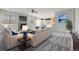 Bright living room with neutral tones, a modern fireplace, and an open layout to the kitchen at 275 Gold Maple St, Brighton, CO 80601