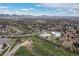 Aerial view features community sports fields and a park surrounded by houses and trees at 6930 S Yukon Way, Littleton, CO 80128