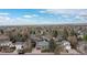 This aerial view showcases a home in a suburban setting with mature trees and neighborhood charm at 6930 S Yukon Way, Littleton, CO 80128