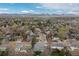 This aerial showcases a residential area with a mountain view in the background at 6930 S Yukon Way, Littleton, CO 80128