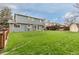 Wide backyard with manicured lawn, wooden fence, and patio, perfect for outdoor activities at 6930 S Yukon Way, Littleton, CO 80128