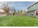 Large backyard with green lawn and wood fence provides ample outdoor space at 6930 S Yukon Way, Littleton, CO 80128