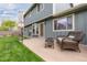 Backyard featuring a patio with outdoor seating and a well-maintained lawn at 6930 S Yukon Way, Littleton, CO 80128