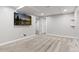 Spacious finished basement featuring a mounted TV and neutral-toned walls and carpet at 6930 S Yukon Way, Littleton, CO 80128