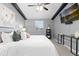 Bedroom with a vaulted ceiling, a large bed, and a TV on the wall is well lit at 6930 S Yukon Way, Littleton, CO 80128