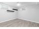 Bedroom with wood-look floors, floating shelves, and a window with blinds at 6930 S Yukon Way, Littleton, CO 80128